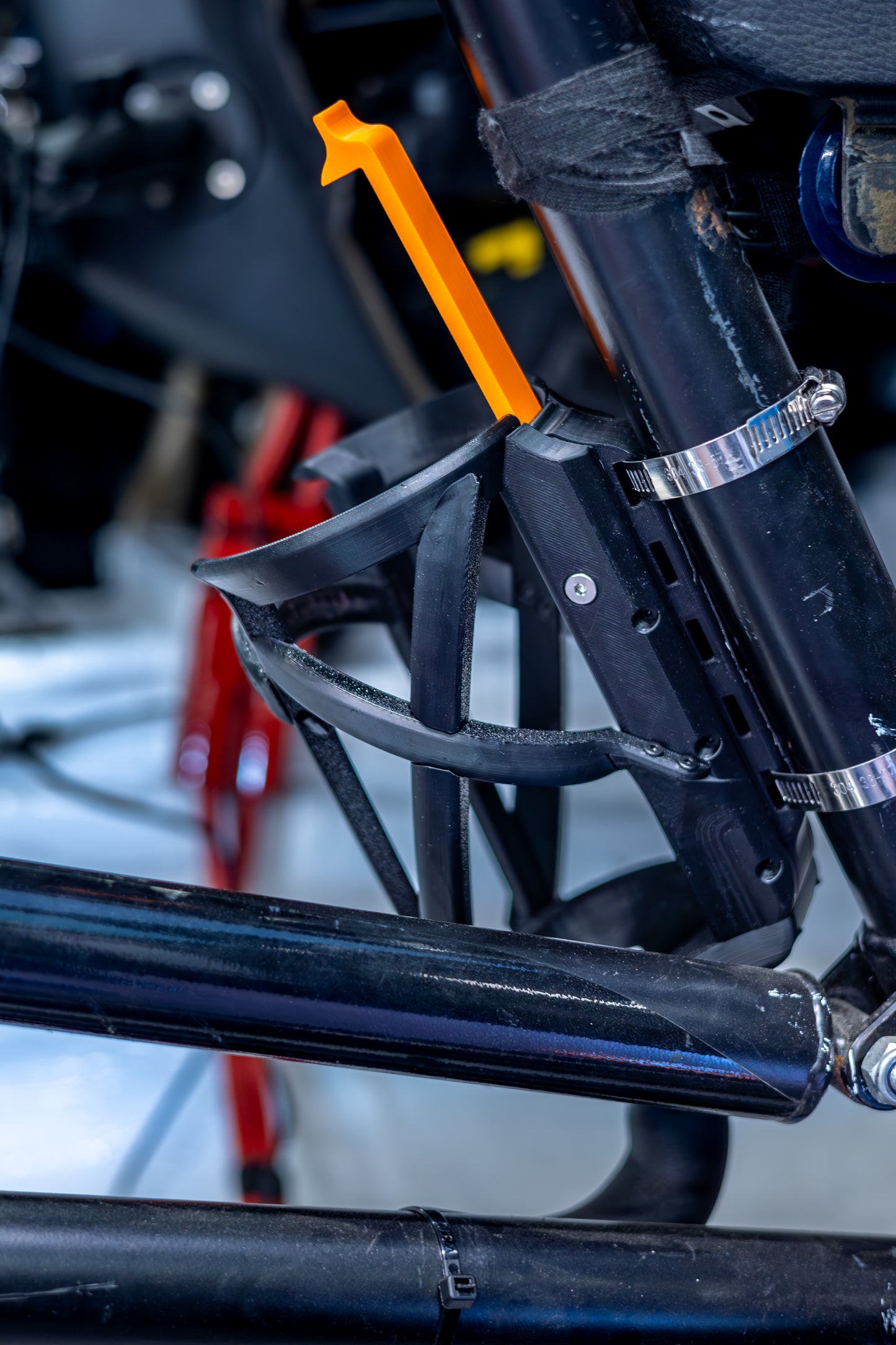 close up of side of racing hydration quick change bottle holder for endurance racing mounted on a roll cage