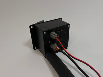 rear of racing hydration unit laying on the side showing a black carbon fiber unit with 2 Deutsch connectors on the rear and a black insulated tube on a white background