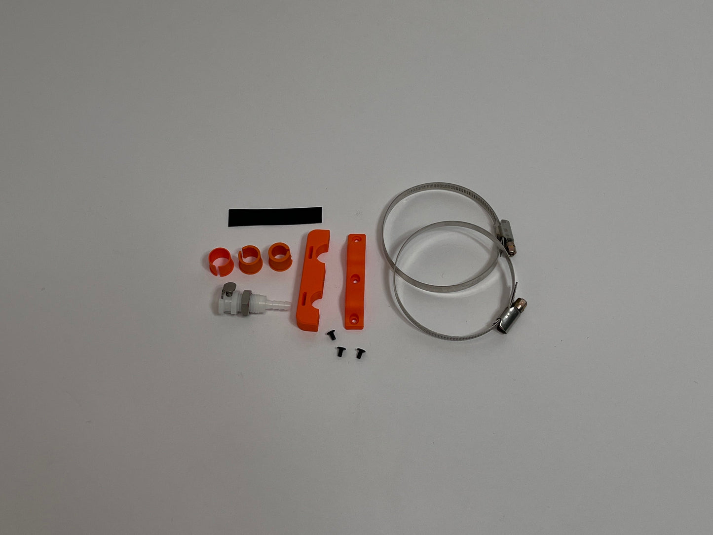 all motorsport drink unit car side connector holder parts included in the kit showing mounting hardware, lower and upper of the connector holder, dry break water fitting and roll cage mounts on a light gray background