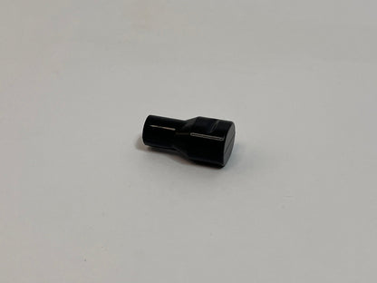 one black silicone bite valve on light gray background