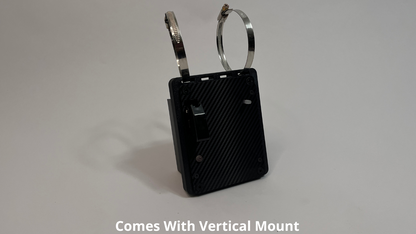 front side of motosport drink pump unit  showing a black carbon fiber unit with 2 Deutsch connectors on the rear with 2 roll cage mounts on the top to mount vertically on a light gray background